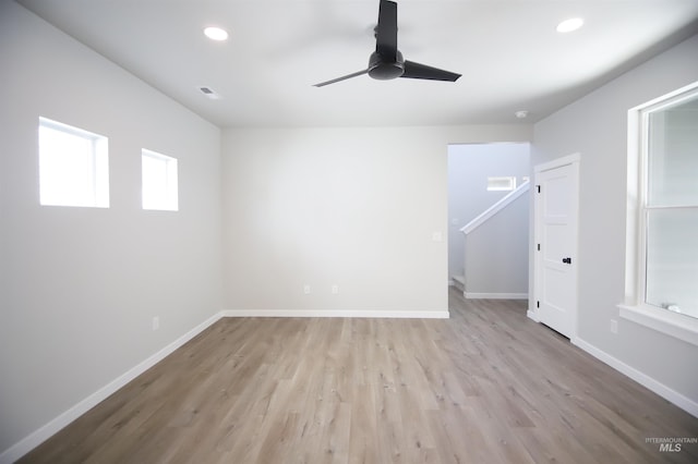 unfurnished room with light wood-type flooring, a wealth of natural light, and recessed lighting