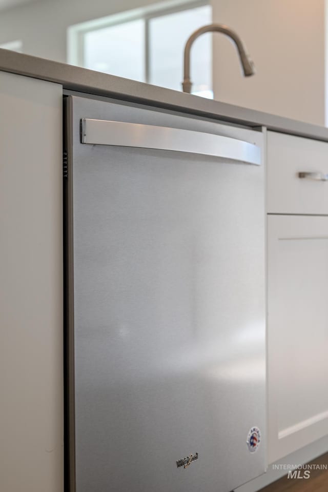 room details featuring white cabinetry and dishwasher