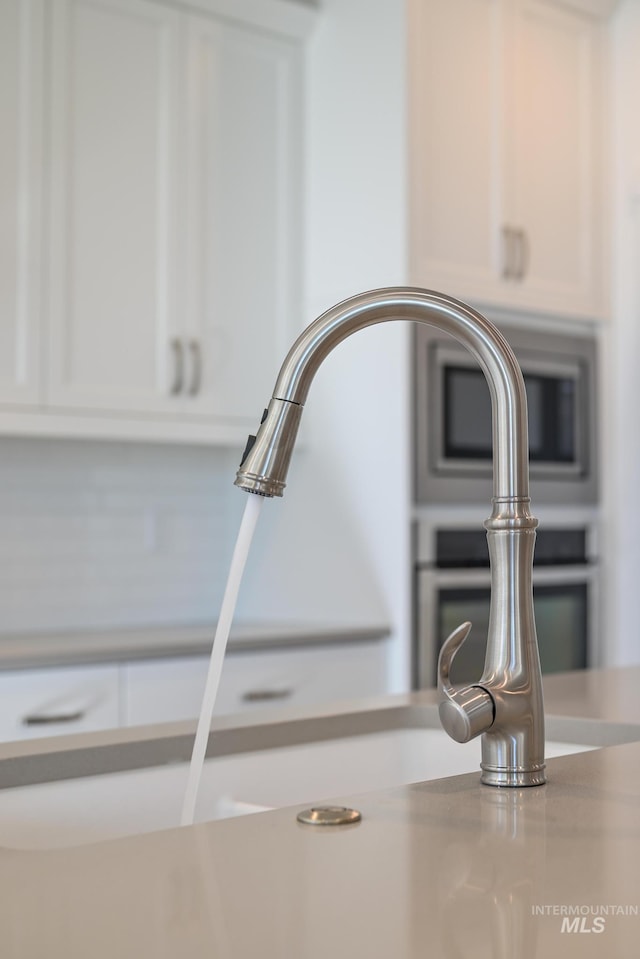 room details with white cabinets and sink