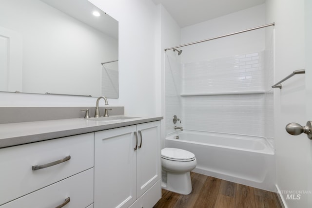 full bathroom with shower / tub combination, hardwood / wood-style floors, vanity, and toilet