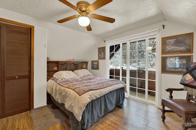 bedroom with wood-type flooring, a closet, vaulted ceiling, and ceiling fan