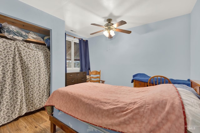 bedroom featuring wood-type flooring and ceiling fan