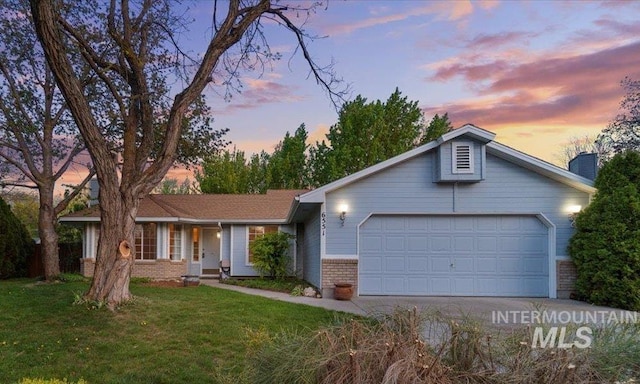 single story home with a garage, a front yard, a chimney, brick siding, and driveway