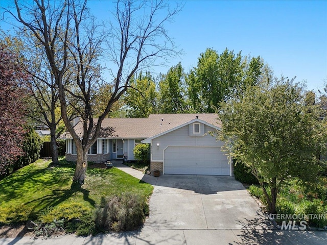 ranch-style house featuring brick siding, a front lawn, an attached garage, and concrete driveway