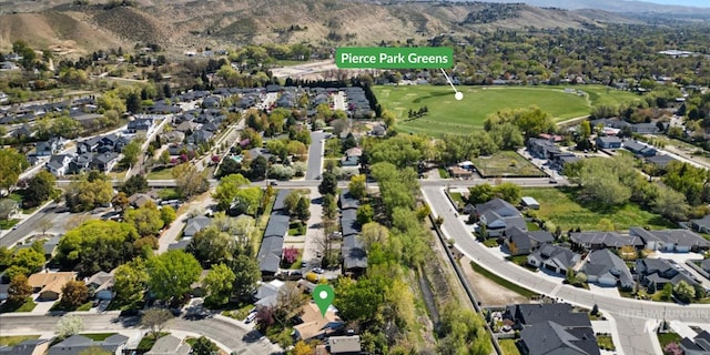 birds eye view of property with a residential view, a mountain view, and golf course view