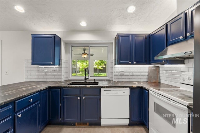 kitchen with white appliances, a textured ceiling, under cabinet range hood, blue cabinets, and a sink