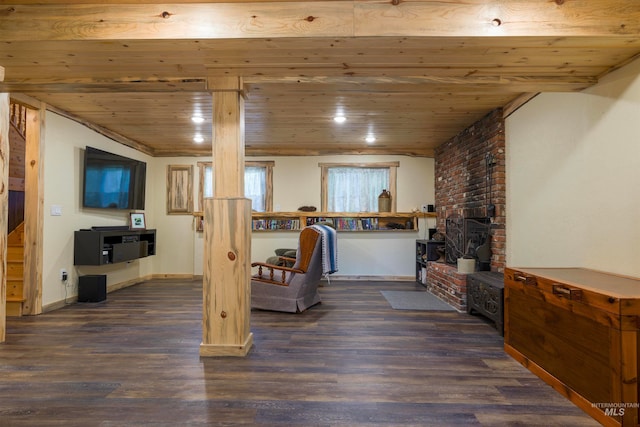 interior space featuring dark wood-type flooring, baseboards, recessed lighting, wooden ceiling, and a fireplace