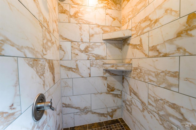 interior details with a tile shower
