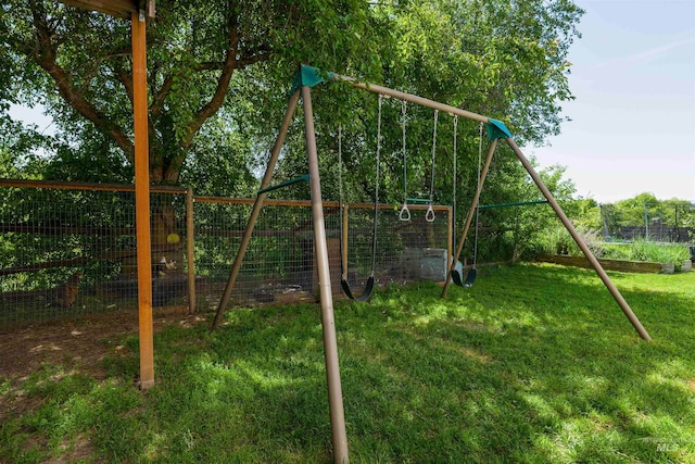 view of jungle gym featuring a yard and fence