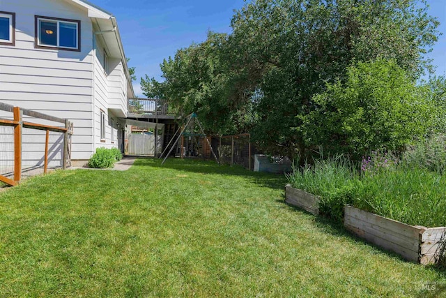 view of yard with fence and a garden