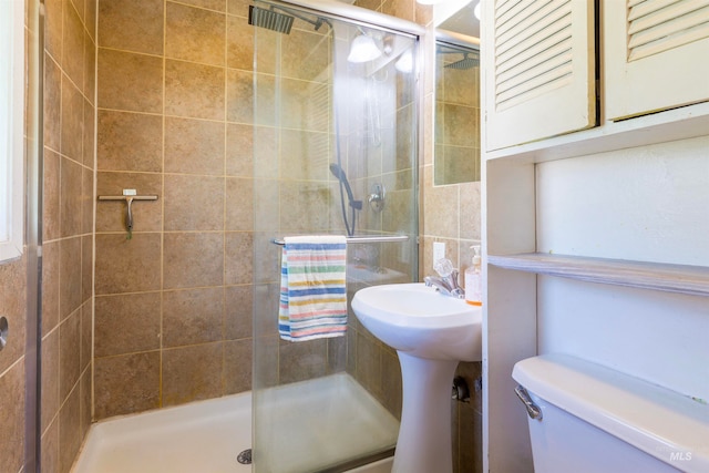 bathroom with toilet and a stall shower