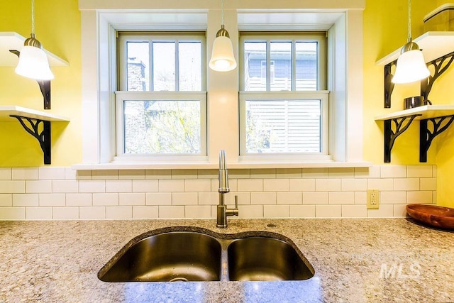 512 N Lincoln St, Moscow, ID 83843 - room details with tasteful backsplash, light stone counters, and a sink
