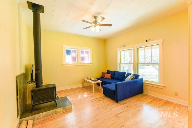 512 N Lincoln St, Moscow, ID 83843 - living area with wood-type flooring, a wood stove, a ceiling fan, and baseboards