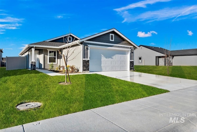 view of front of property featuring a front lawn and a garage