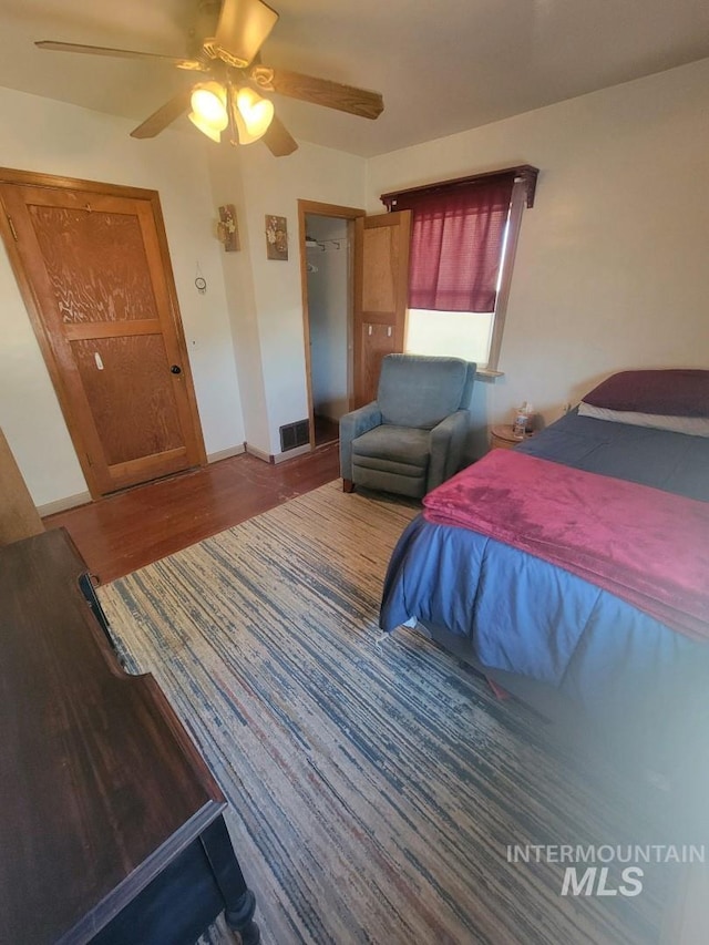 bedroom with ceiling fan, hardwood / wood-style flooring, and a closet