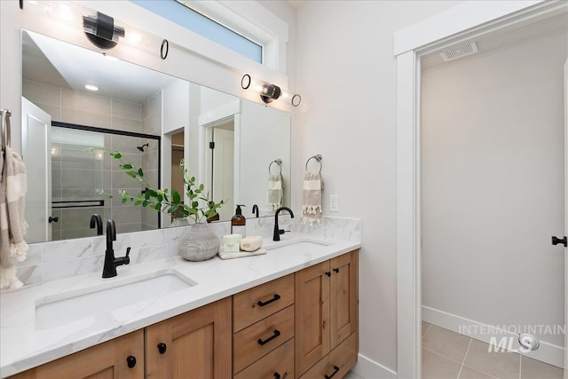 3892 W Stone House Ln, Eagle, ID 83616 - bathroom with double vanity, tile patterned flooring, a stall shower, and baseboards