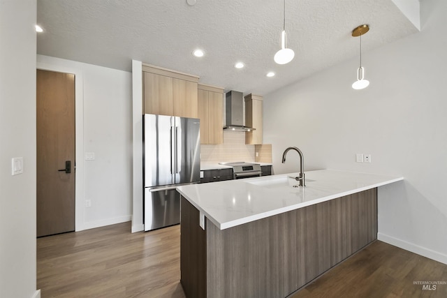 4340 E Haystack St Unit 210, Boise, ID 83716 - kitchen featuring appliances with stainless steel finishes, wall chimney exhaust hood, a peninsula, dark wood-style floors, and backsplash