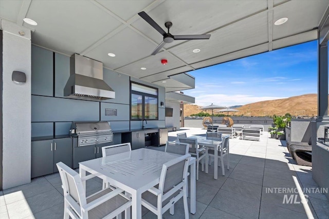 4340 E Haystack St Unit 210, Boise, ID 83716 - view of patio / terrace with outdoor dining area, a mountain view, area for grilling, and a ceiling fan