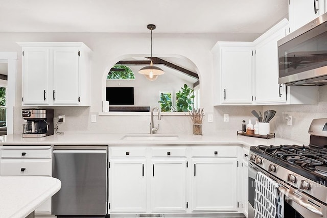 1866 S Goldking Way, Boise, ID 83709 - kitchen featuring appliances with stainless steel finishes, a sink, healthy amount of natural light, and white cabinets