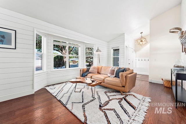 1866 S Goldking Way, Boise, ID 83709 - living room with vaulted ceiling, plenty of natural light, wooden walls, dark wood-style floors, and a chandelier