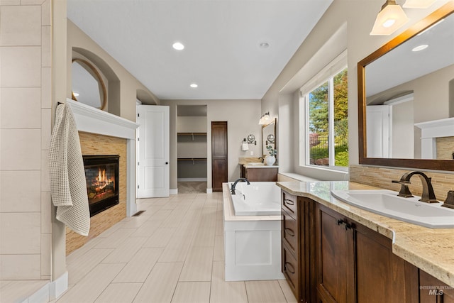 bathroom with vanity, a bathtub, and hardwood / wood-style flooring