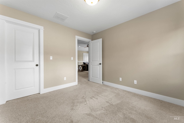 unfurnished bedroom with light colored carpet