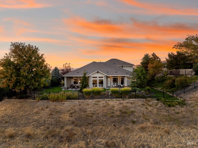 view of back house at dusk