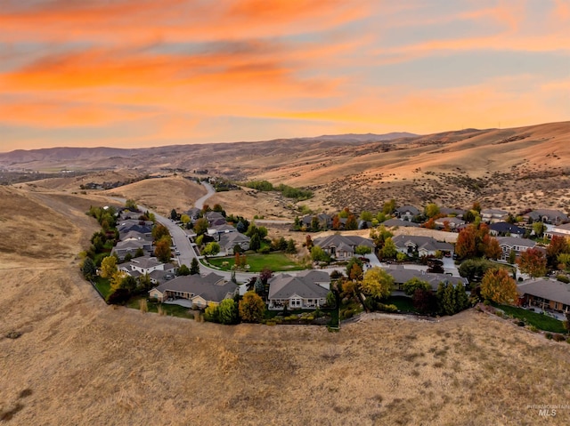 aerial view at dusk featuring a mountain view