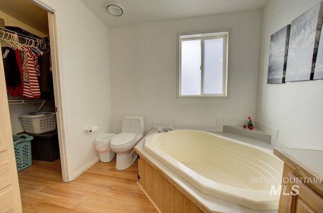 bathroom featuring toilet, a bathtub, and hardwood / wood-style floors