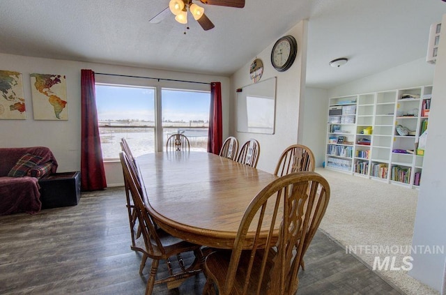 dining room featuring lofted ceiling, dark wood-type flooring, and ceiling fan