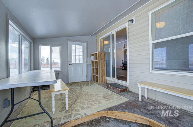 unfurnished sunroom featuring lofted ceiling