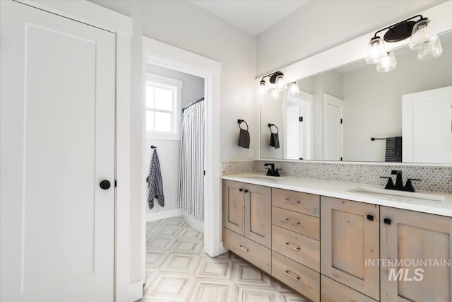 full bath with backsplash, double vanity, and baseboards