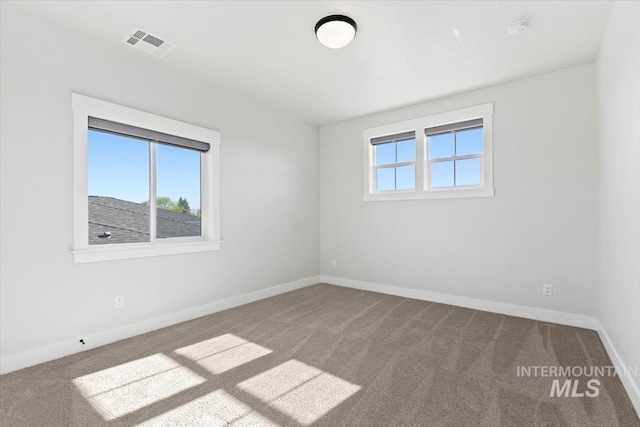 unfurnished room with carpet flooring, baseboards, and a smoke detector