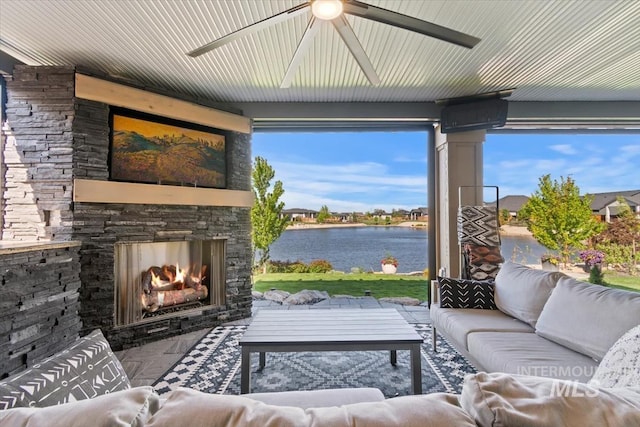 sunroom / solarium featuring a water view