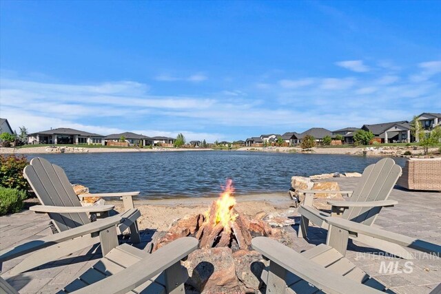 water view featuring a fire pit and nearby suburban area