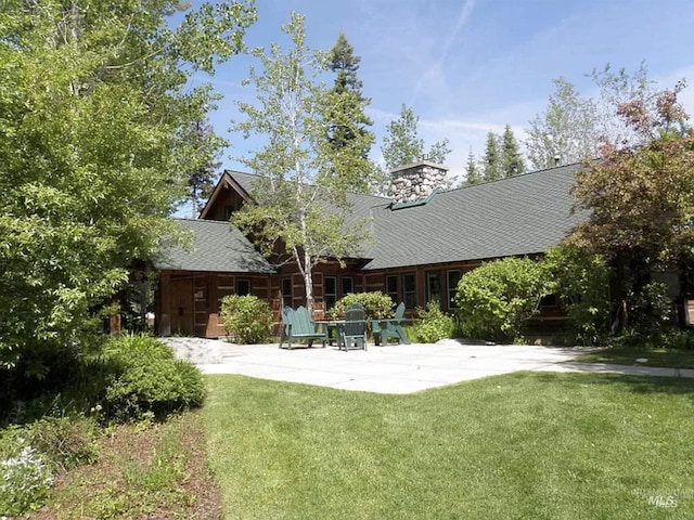 1319 Hearthstone Ct Unit 3-A, Mccall, ID 83638 - back of property with a yard, a patio, and a chimney