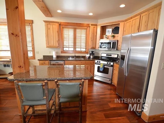 1319 Hearthstone Ct Unit 3-A, Mccall, ID 83638 - kitchen featuring appliances with stainless steel finishes, a sink, light brown cabinetry, recessed lighting, and a kitchen island