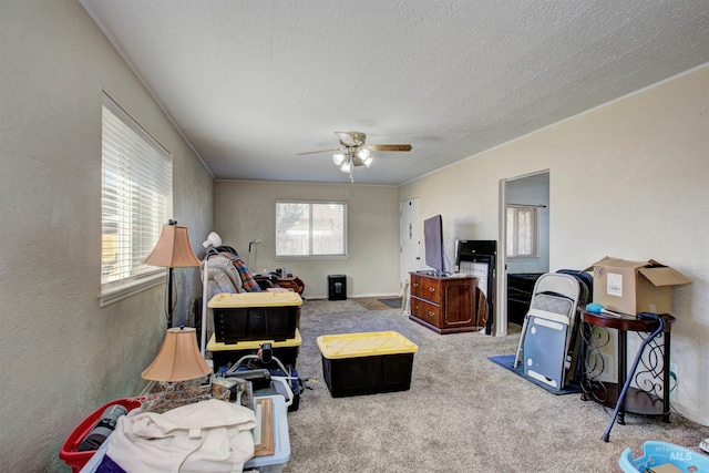 bedroom with a textured ceiling, carpet, a textured wall, and ceiling fan