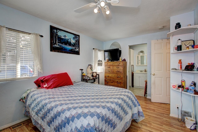 bedroom featuring visible vents, baseboards, a ceiling fan, and light wood finished floors