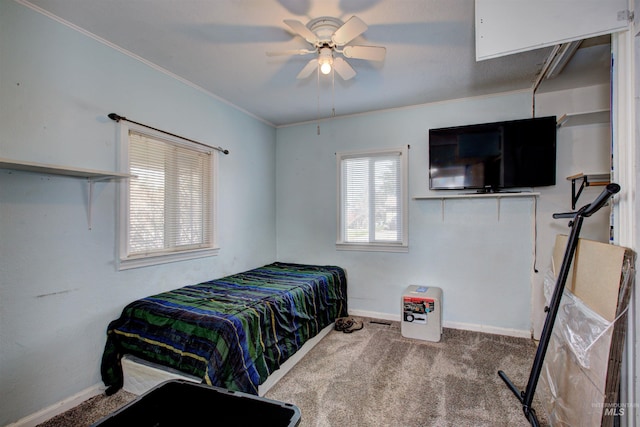 bedroom featuring ornamental molding, a ceiling fan, baseboards, and carpet floors