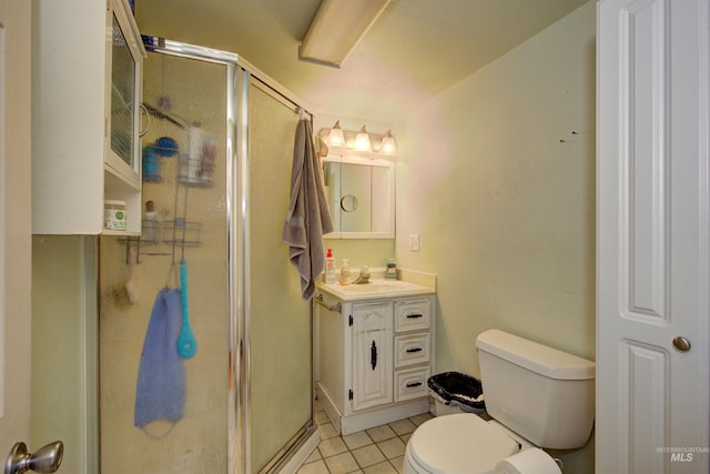 full bathroom featuring toilet, a stall shower, vanity, and tile patterned flooring