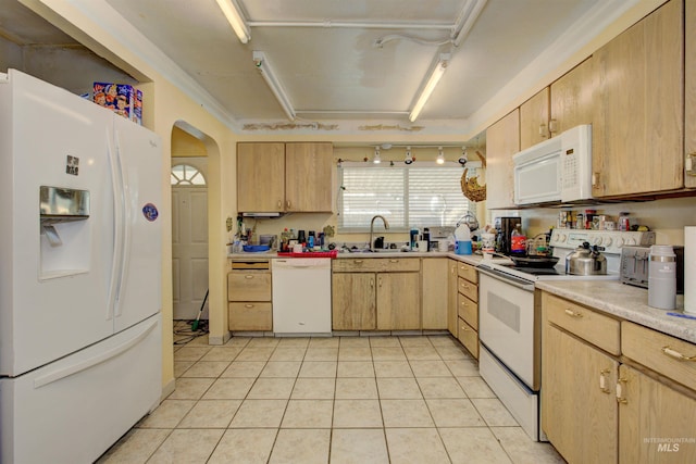 kitchen featuring white appliances, light tile patterned flooring, light brown cabinetry, a sink, and light countertops