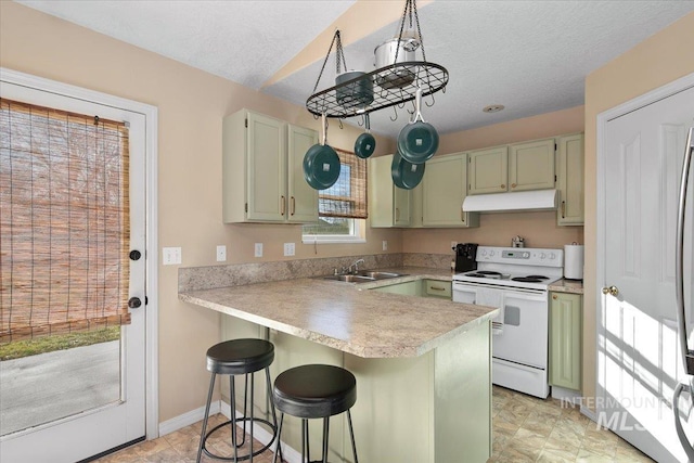 kitchen featuring sink, green cabinets, white range with electric cooktop, kitchen peninsula, and a breakfast bar