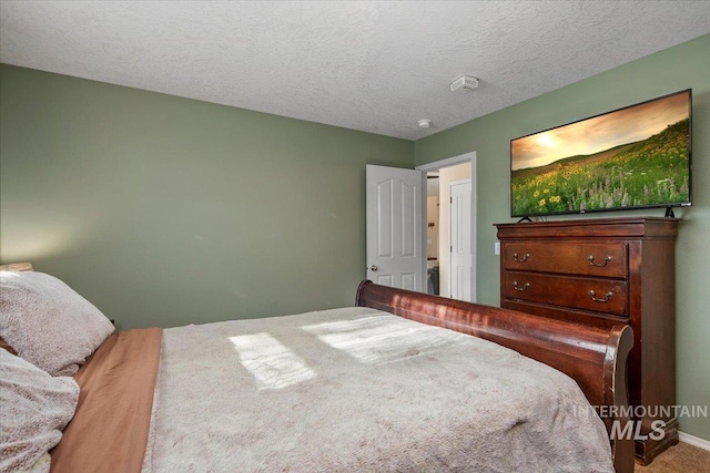 carpeted bedroom featuring a textured ceiling