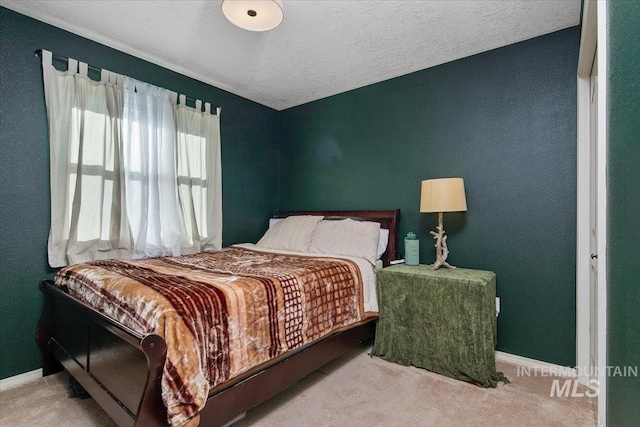 bedroom with a textured ceiling and carpet floors