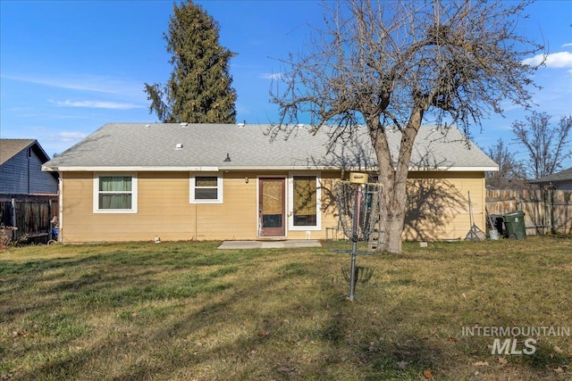 back of property featuring a patio and a lawn