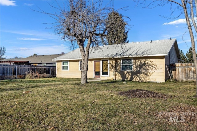 back of house with a yard