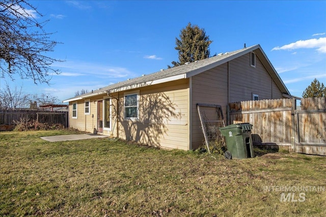 rear view of house with a yard and a patio area