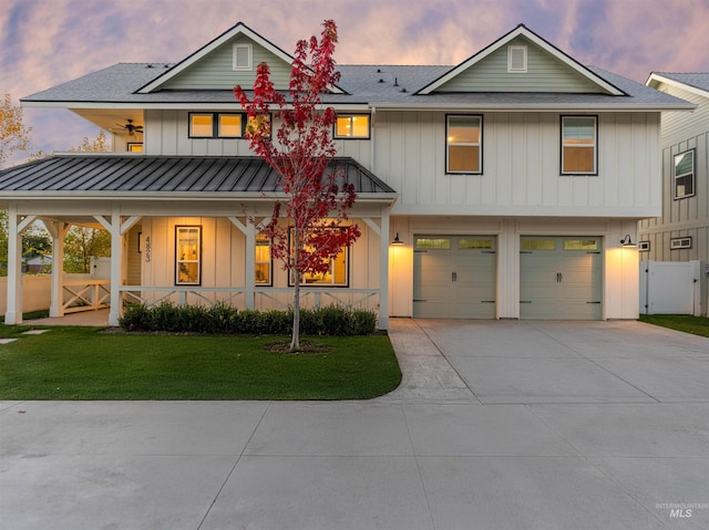 4823 N Mitchell St, Boise, ID 83704 - view of front of home with a gate, covered porch, board and batten siding, driveway, and a standing seam roof