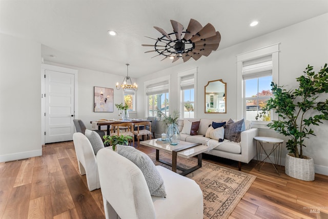 4823 N Mitchell St, Boise, ID 83704 - living room featuring a chandelier, baseboards, wood-type flooring, and recessed lighting